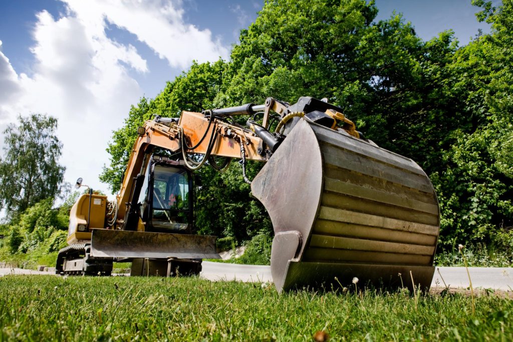 a backhoe truck on the field